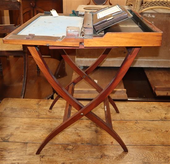 An Edwardian mahogany coaching writing table by Albert Barker Ltd, London W.61cm